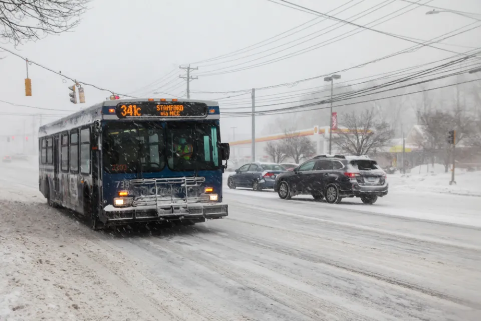 CTtransit bus driving through snowy street in Norwalk, Connecticut
